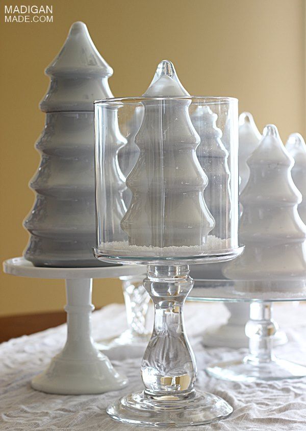 Milk glass trees in hurricane vases... look like big snow globes!
