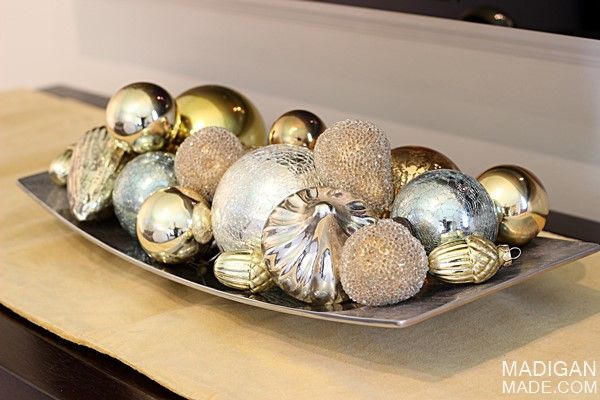 Gold and silver vintage style ornaments in a tray 