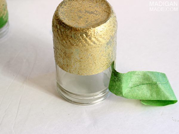 Paint jars with gold glitter paint for dipped effect using painter's tape