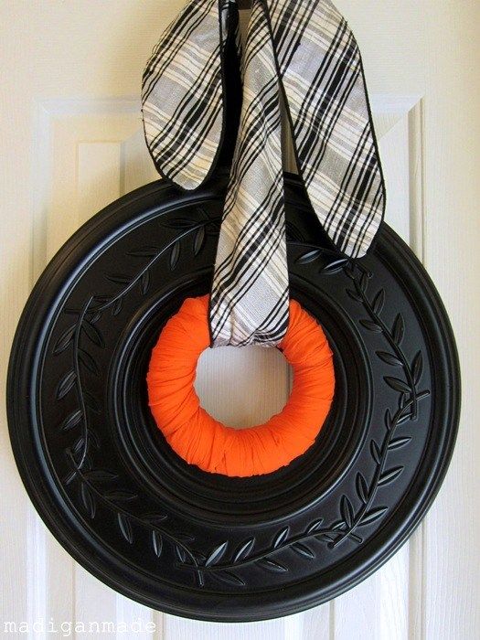 black, white and orange wreath from a ceiling medallion