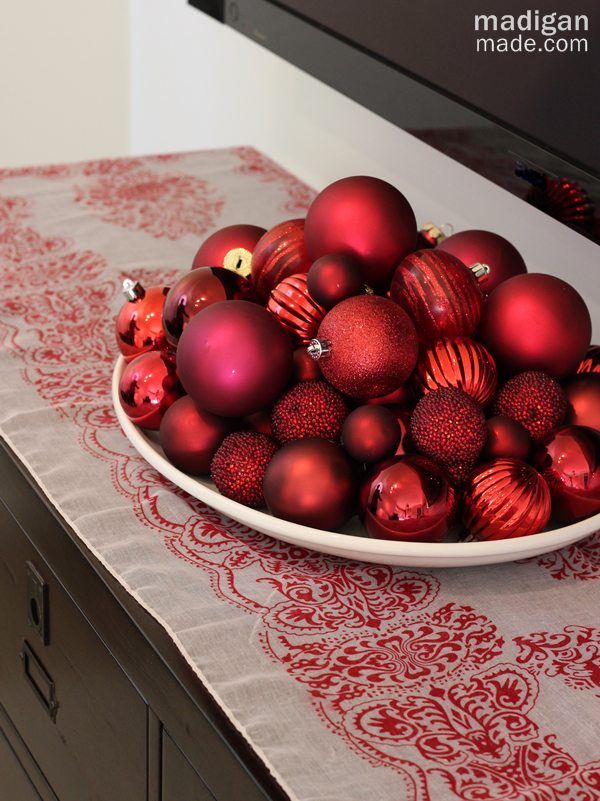 elegant and big bowl of red ornaments - part of the holiday home tour at madiganmade.com